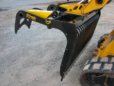 A skid steer with an EZ-Grapple attachment.